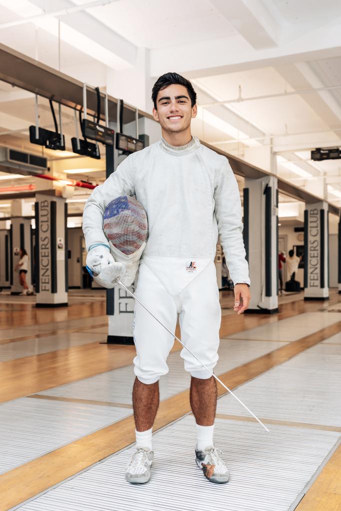 Mitchell Saron holding a fencing helmet at The Fencer's Club in Manhattan