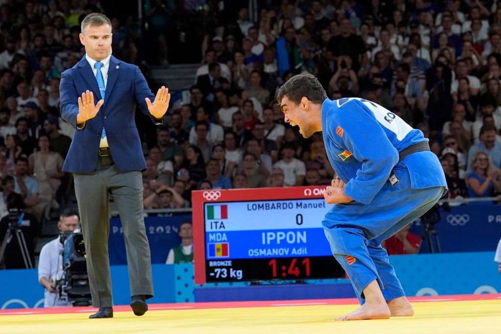 Moldova's judo athlete Adil Osmanov celebrating his victory over Italy's Manuel Lombardo in the men's -73 kg bronze medal final at the 2024 Paris Summer Olympics