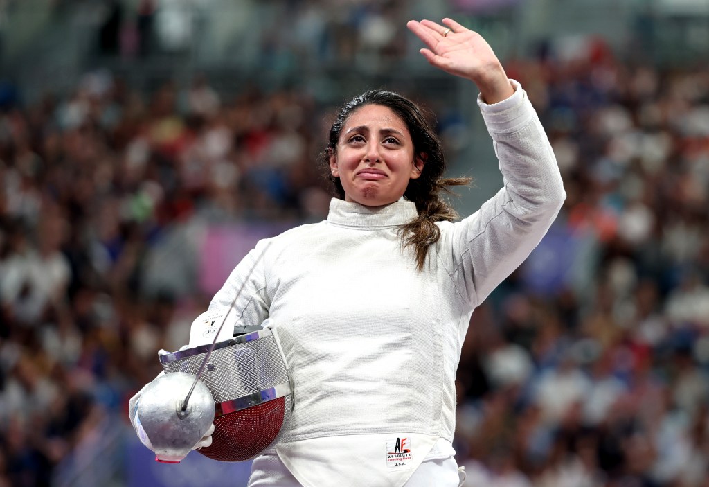 Nada Hafez of Team Egypt applauds fans after her victory in the Fencing Women's Sabre Individual Table of 32 on day three of the Olympic Games Paris 2024 at Grand Palais on July 29, 2024 in Paris, France.