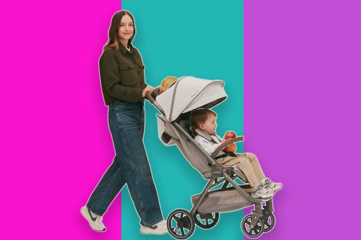 A woman pushing a stroller with a baby