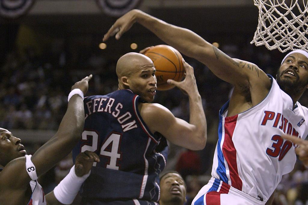 Richard Jefferson #24 of the New Jersey Nets is pressured by Ben Wallace #3 and Rasheed Wallace #30 of the Detroit Pistons in Game one of the Eastern Conference Semifinals during the 2004 NBA Playoffs on May 3, 2004 at The Palace of Auburn Hills, Michigan. The Pistons won 78-56. 