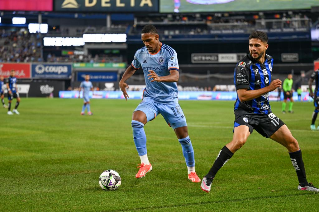 New York City FC defender Christian McFarlane (18) runs with the ball chased by Queretaro FC player Alan Medina (11) at Yankee Stadium on July 28, 2024.