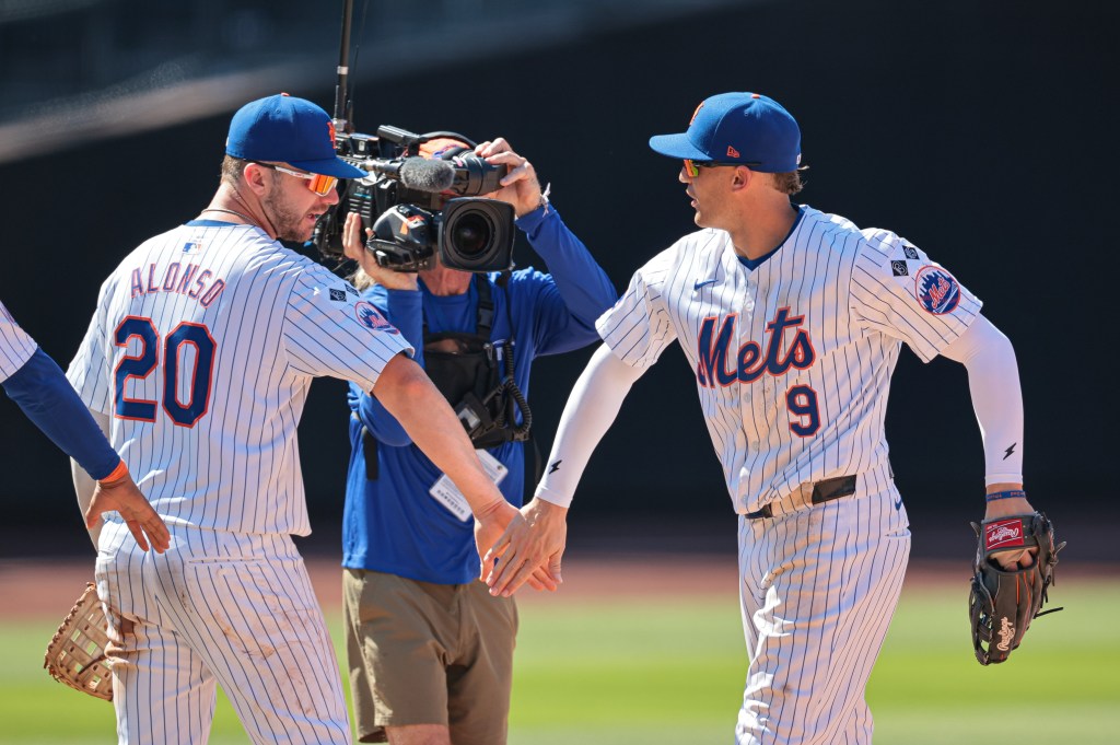 New York Mets first baseman Pete Alonso (20) and left fielder Brandon Nimmo (9) celebrate after defeating the Washington Nationals at Citi Field.