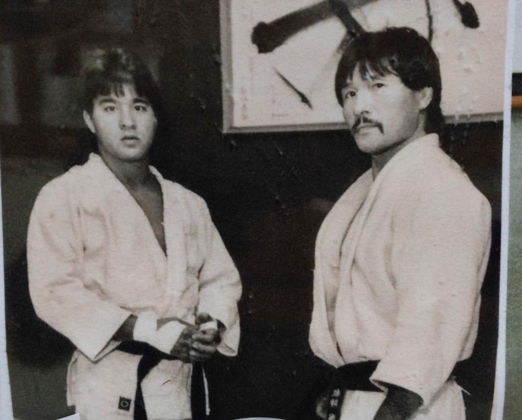 Nick Yonezuka and his instructor in karate uniforms at home, continuing the Yonezuka family's legacy in Judo.