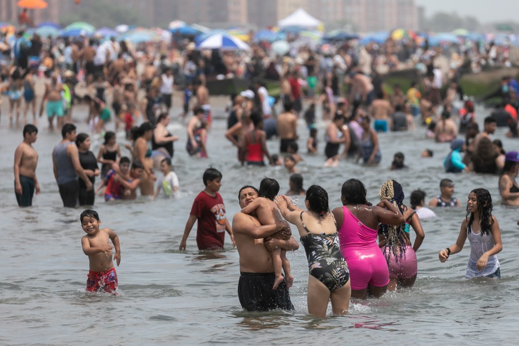 People cool off at the beach on June 23, 2024 in Coney Island