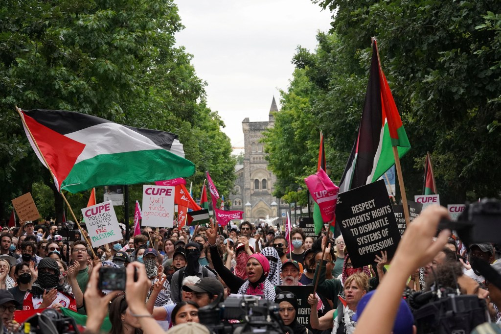 Pro-Palestinian demonstrators are seen above during a protest at the University of Toronto on July 3. A prominent Wall Street law firm says it will screen job applicants who take part in anti-Israel demonstrations.