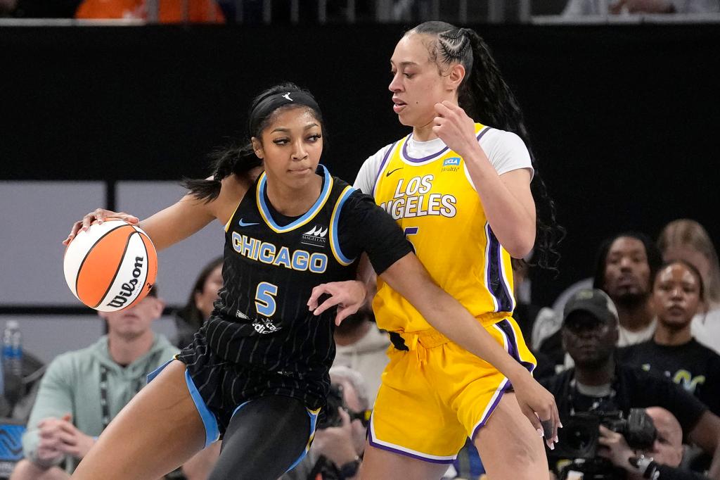 Chicago Sky's Angel Reese (5) drives to the basket as Los Angeles Sparks' Dearica Hamby defends during the first half of a WNBA basketball game, May 30, 2024, in Chicago. 