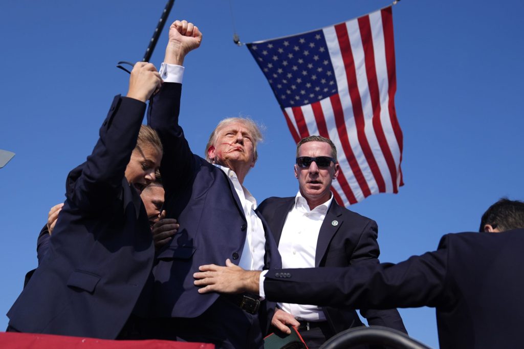 Republican presidential candidate former President Donald Trump is surrounded by U.S. Secret Service agents at a campaign rally, Saturday, July 13, 2024, in Butler, Pennsylvania.