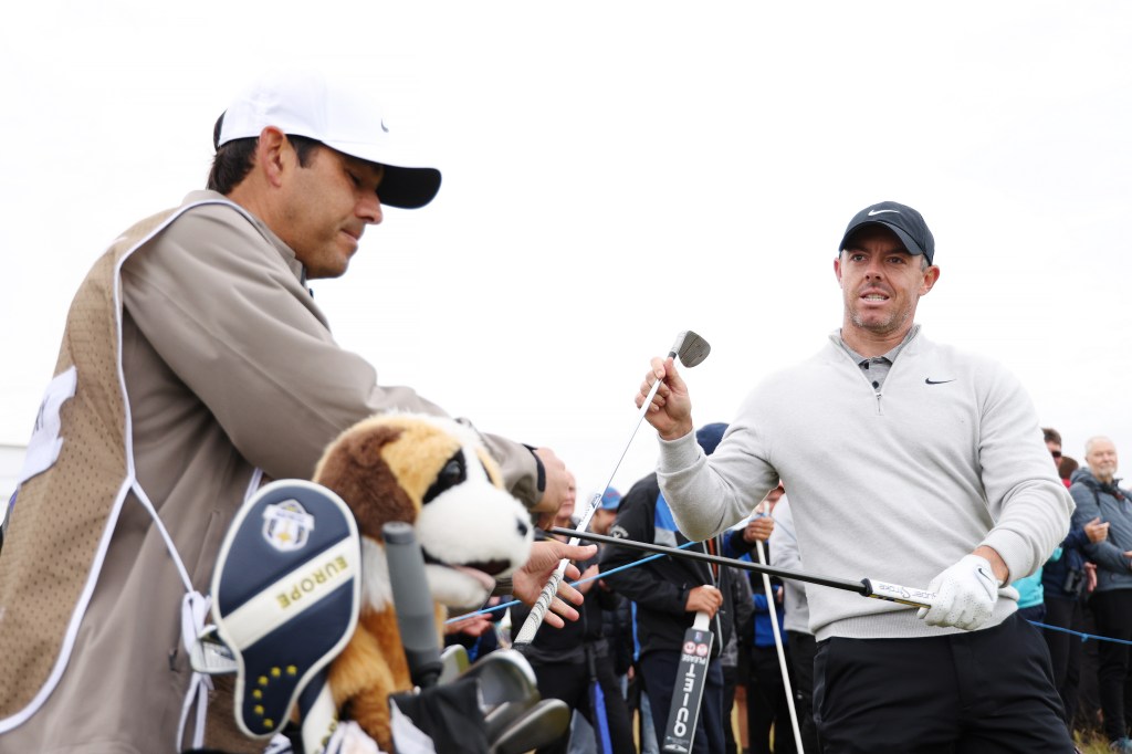 Rory McIlroy of Northern Ireland choosing his putter on the ninth hole at the Genesis Scottish Open in North Berwick, Scotland