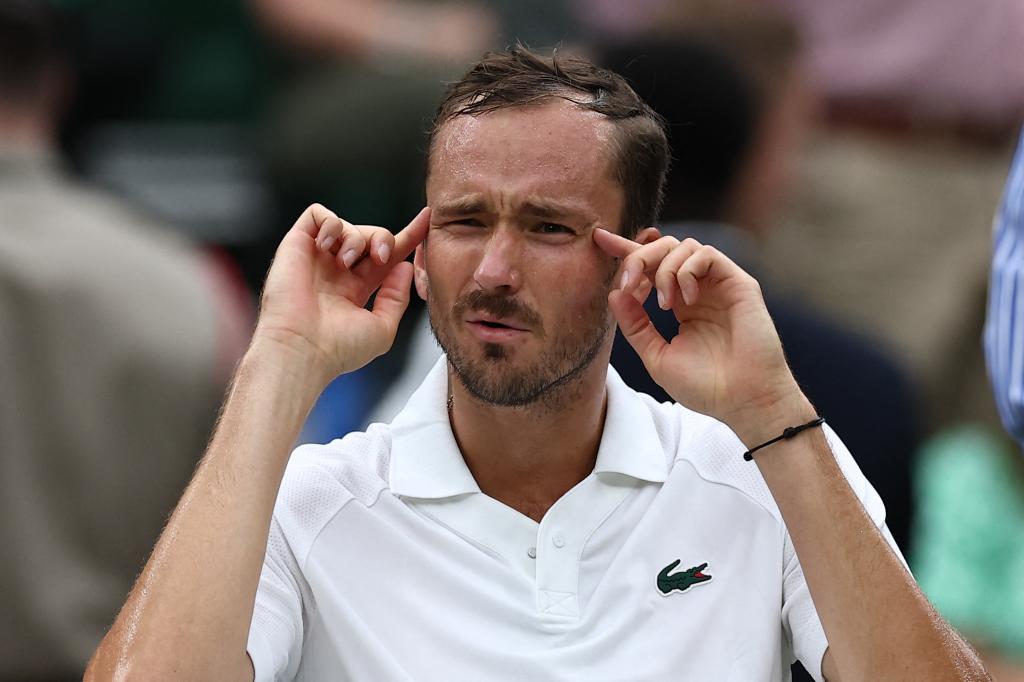 Russia's Daniil Medvedev gestures to his coach as he reacts after losing the first set to France's Alexandre Muller during their men's singles second round tennis match on the third day of the 2024 Wimbledon Championships 