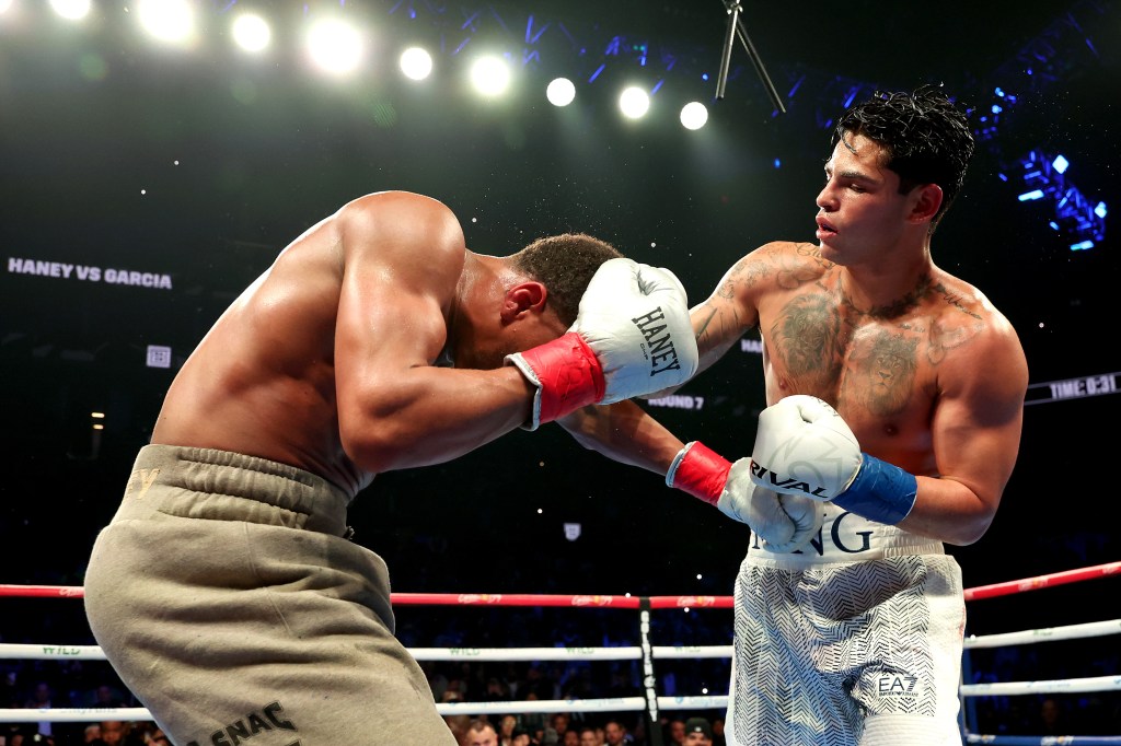 Ryan Garcia (white trunks) punches Devin Haney (gray trunks) during their WBC Super Lightweight title bout at Barclays Center on April 20, 2024 in New York City.