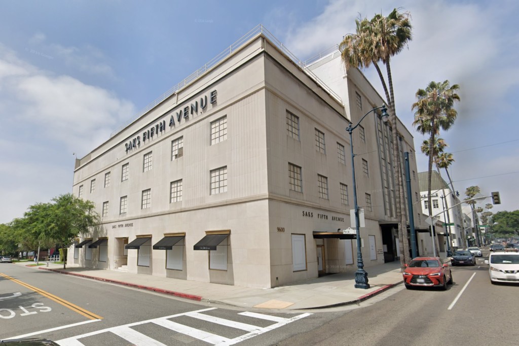 Empty former Saks Fifth Avenue women's store at 9600 Wilshire Blvd., Beverly Hills, surrounded by palm trees with plans for a hotel in progress