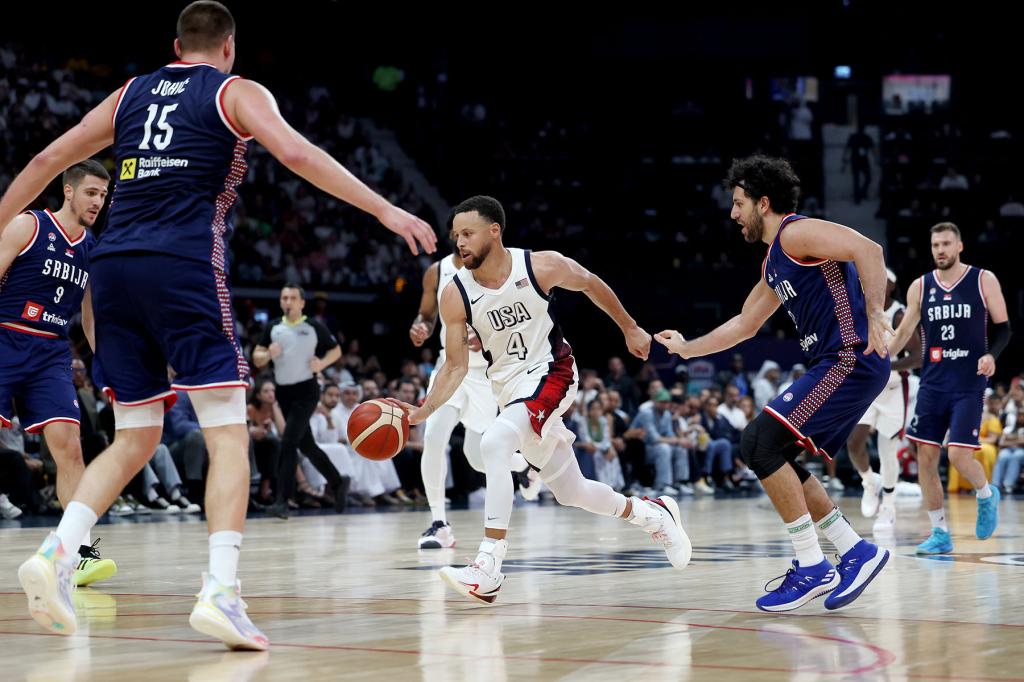 Stephen Curry #4 of the United States dribbles the ball up the court during the first half of an exhibition game between the United States and Serbia ahead of the Paris Olympic Games at Etihad Arena on July 17, 2024 in Abu Dhabi, United Arab Emirates. 