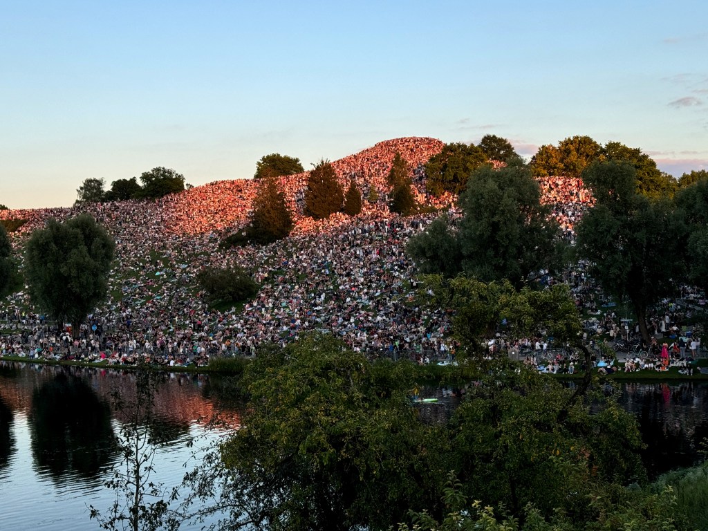 Thousands of Swift fans gather near concert venue to listen to her performance at the Olympiaberg in the Olympiapark in Munich, Germany