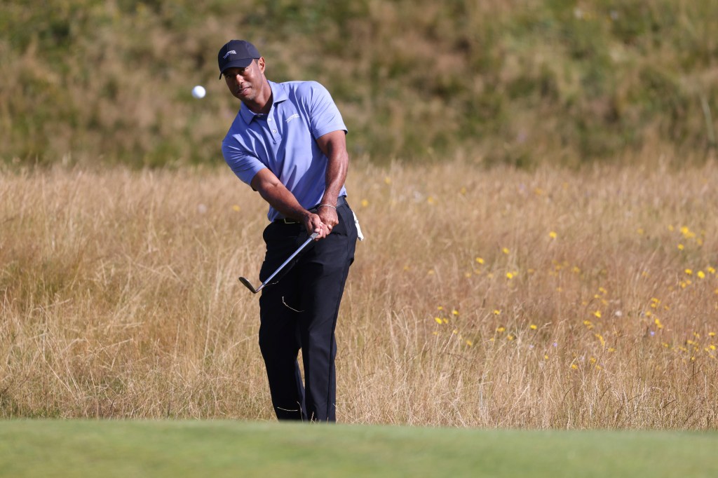 Tiger Woods chipping onto the 6th green during a practice round for the British Open Golf Championships at Royal Troon golf club in Scotland