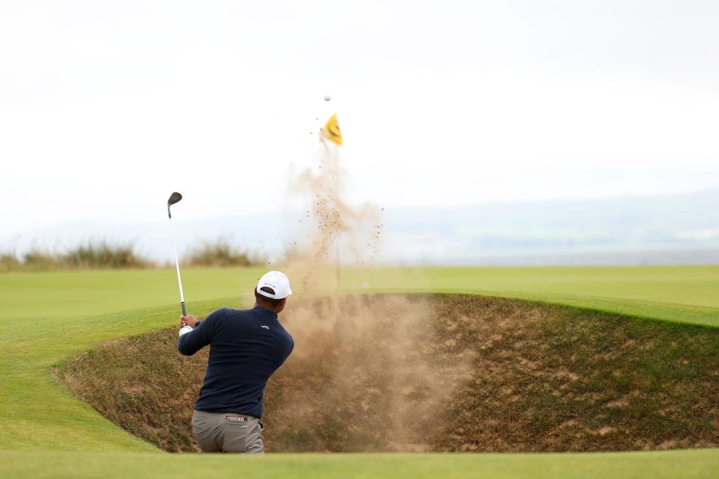 Tiger Woods playing a bunker shot on the fifth hole during The 152nd Open championship at Royal Troon, Scotland