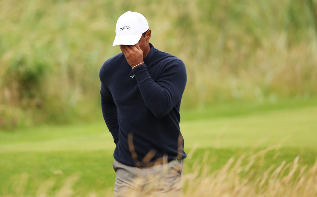 Tiger Woods, wearing a white hat, reacting as he walks off the third tee during day two of The 152nd Open championship at Royal Troon, Scotland