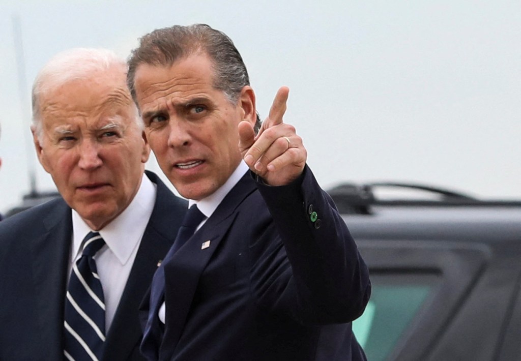 U.S. President Joe Biden stands with his son Hunter Biden at the Delaware Air National Guard Base, pointing at something after Hunter's conviction on gun charges trial