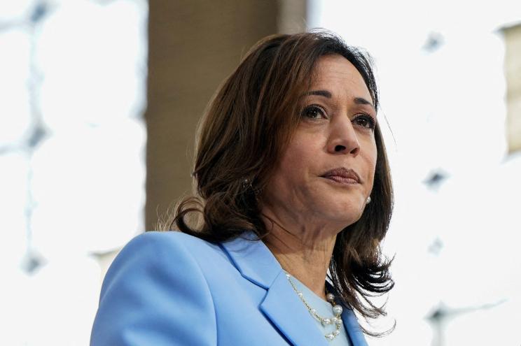 U.S. Vice President Kamala Harris in a blue suit and President Joe Biden at a campaign event at Girard College in Philadelphia, 2024