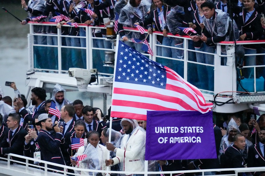 Flagbearers Coco Gauff and Lebron James travel with teammates along the Seine River in Paris, France, during the opening ceremony of the 2024 Summer Olympics, Friday, July 26, 2024.