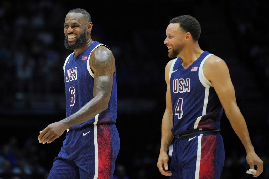 LeBron James and Stephen Curry smiling during an exhibition basketball game between the United States and South Sudan at the O2 Arena in London