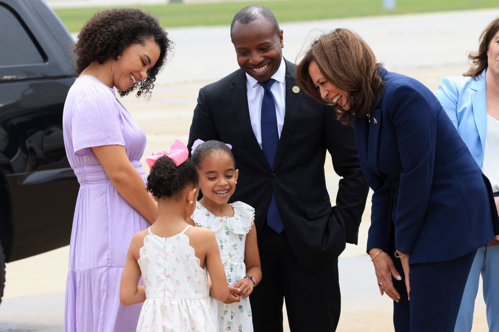 US Vice President and Democratic Presidential candidate Kamala Harris is greeted by Milwaukee Mayor Cavalier Johnson, his wife Dominique Johnson and their two daughters, as she arrives in Milwaukee, Wisconsin, on July 23, 2024. 