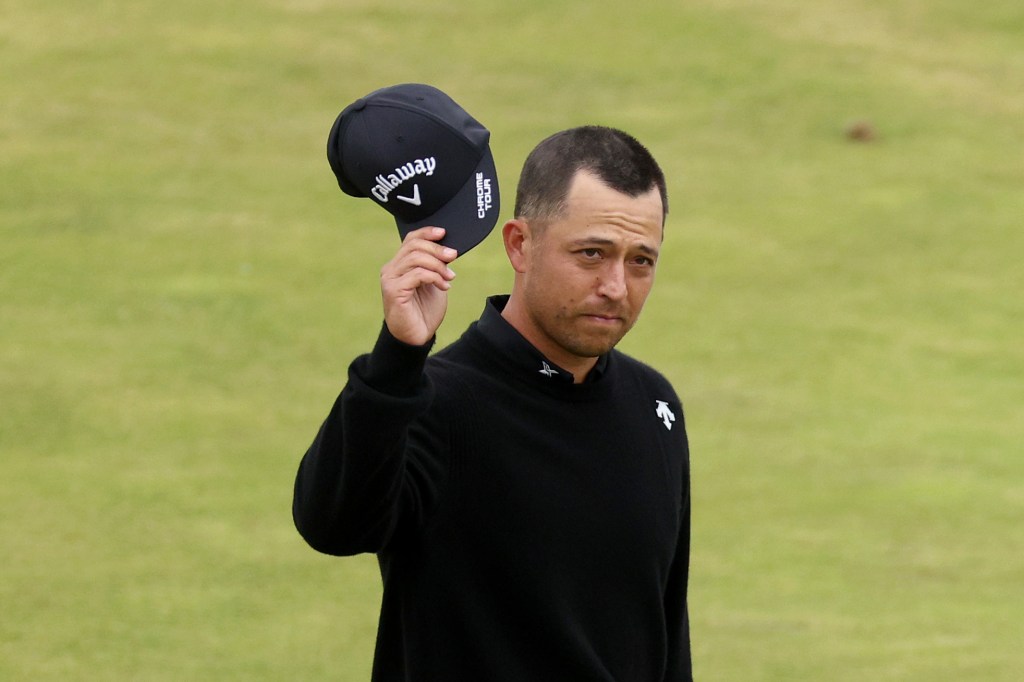 Xander Schauffele acknowledges the crowd on the 18th green Sunday as he finished his British Open victory.