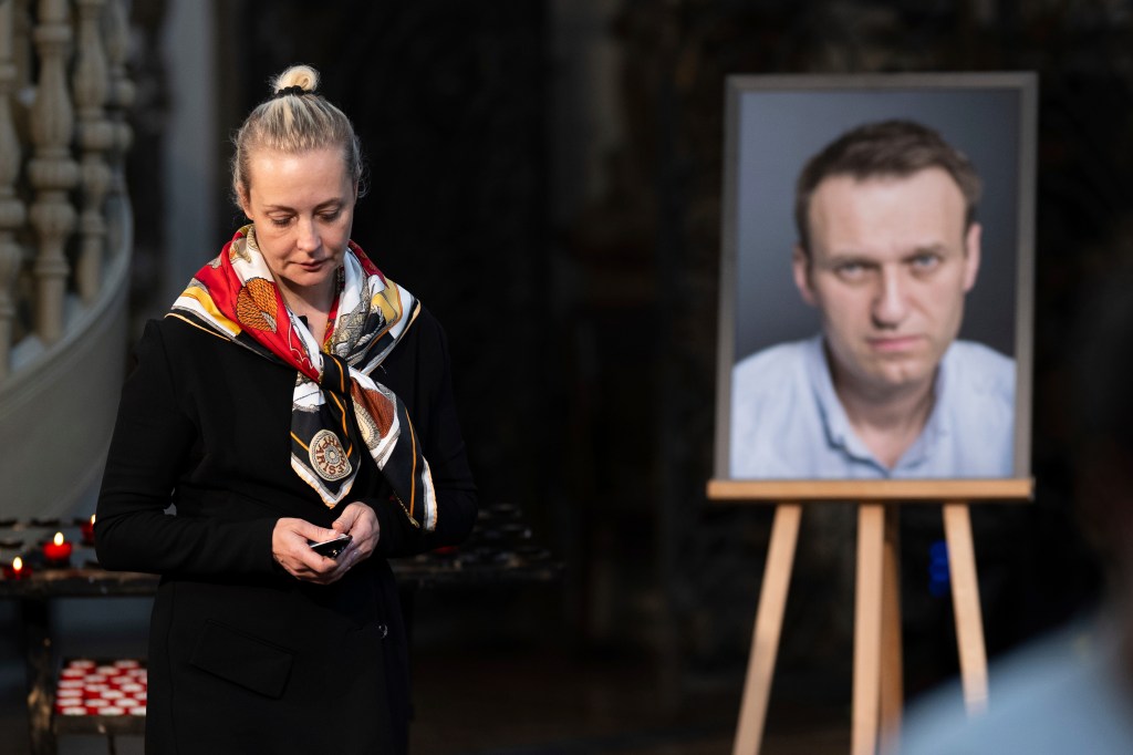 Yulia Navalnaya stands next to a photo of her husband in St. Mary's Church after a service celebrating his birthday on June 4, 2024.
