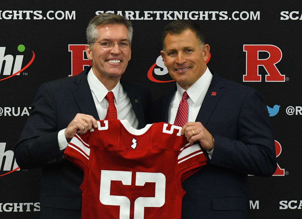 Rutgers AD Pat Hobbs holds a Rutgers jersey with Greg Schiano at a press conference to name the new head coach, Wednesday, Dec. 4, 2019, at the Hale Center Team Meeting Room at Rutgers University in  Piscataway, NJ. 