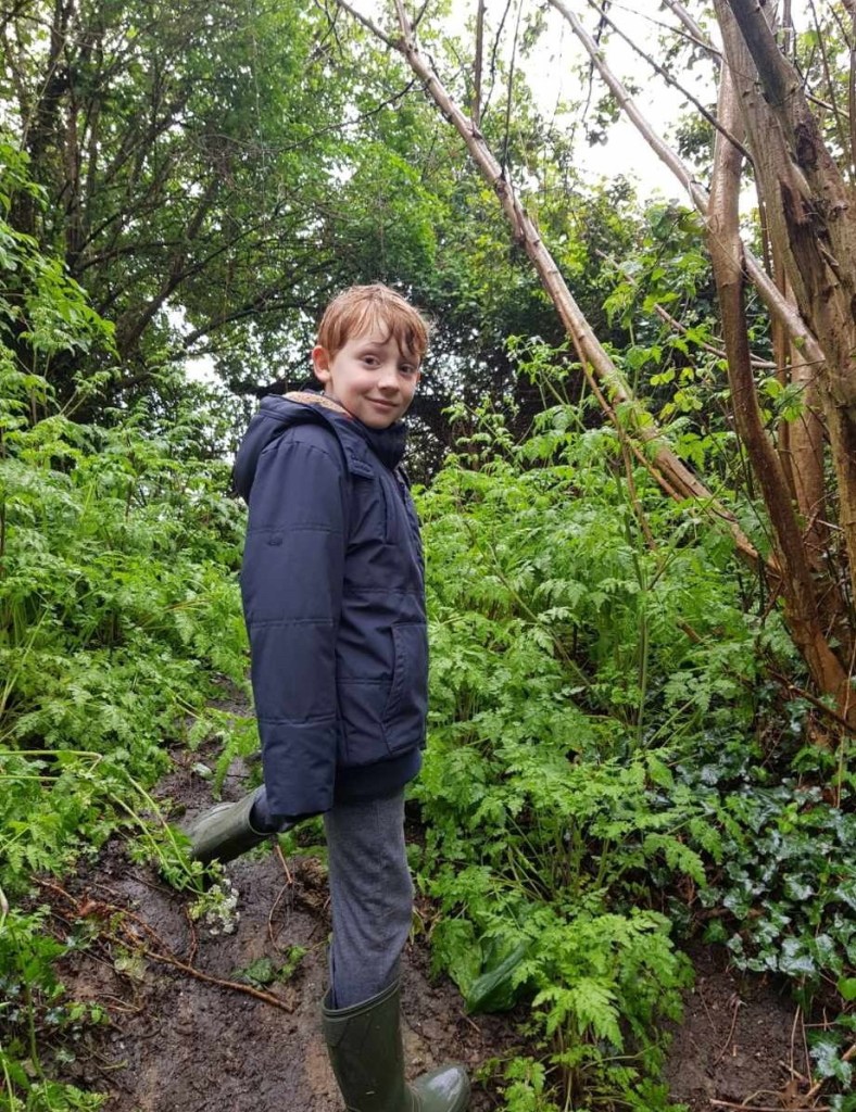 12-year-old boy, Rowan Brannan, holding a 2,000-year-old gold Roman bracelet he discovered in a field in Sussex, England