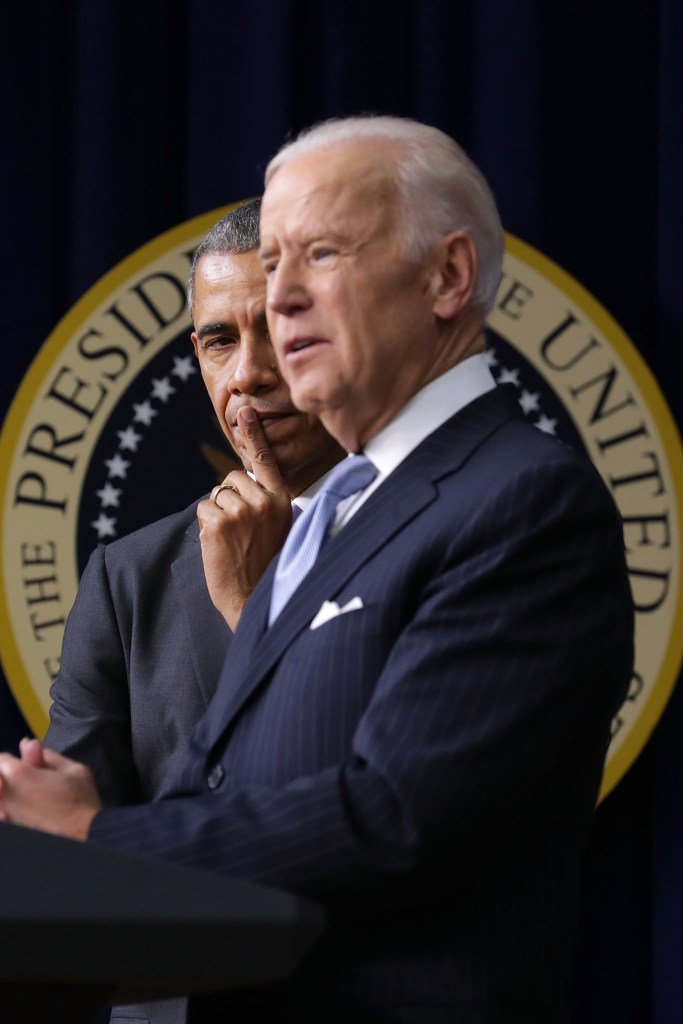 President Barack Obama (L) listens to Vice President Joe Biden deliver remarks before signing the 21st Century Cures Act into law at the Eisenhower Executive Office Building December 13, 2016 in Washington, DC