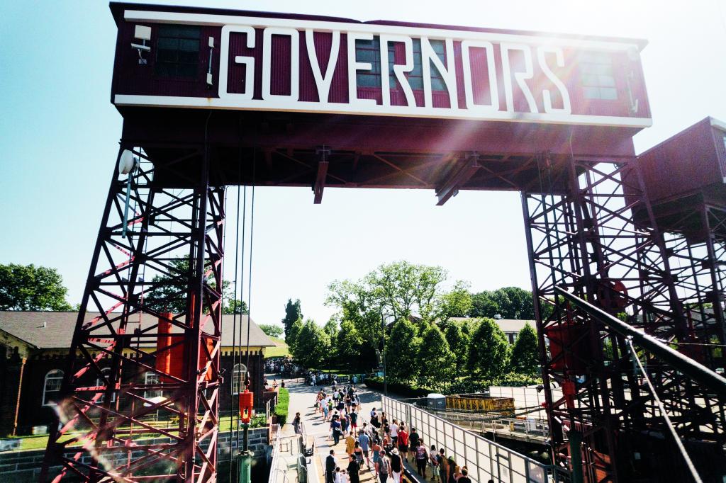 Governors Island entrance with people walking through it.