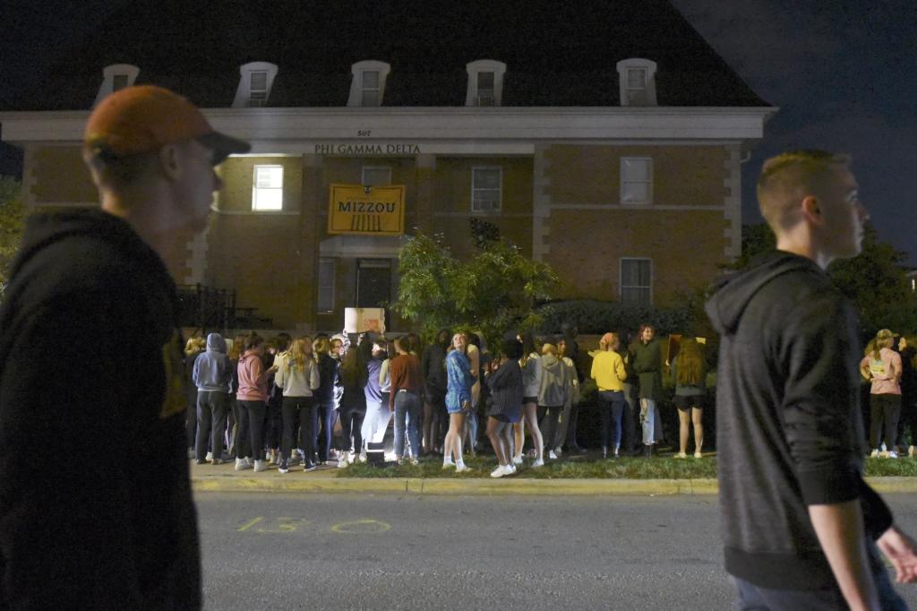 Protestors, opposing fraternity hazing, sexual assault and demanding accountability, chant outside the Phi Gamma Delta fraternity on Wednesday, Oct. 20, 2021, in Columbia, Mo.