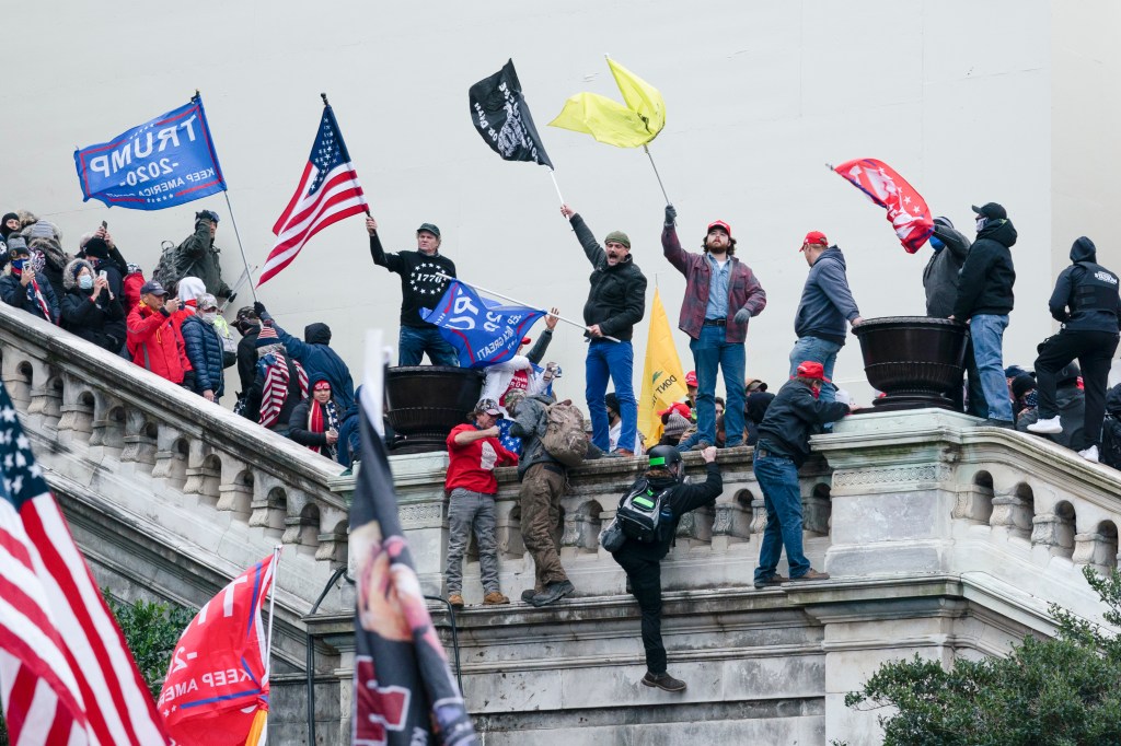 Rioters waving flags on the West Front of the U.S. Capitol on January 6, 2021
