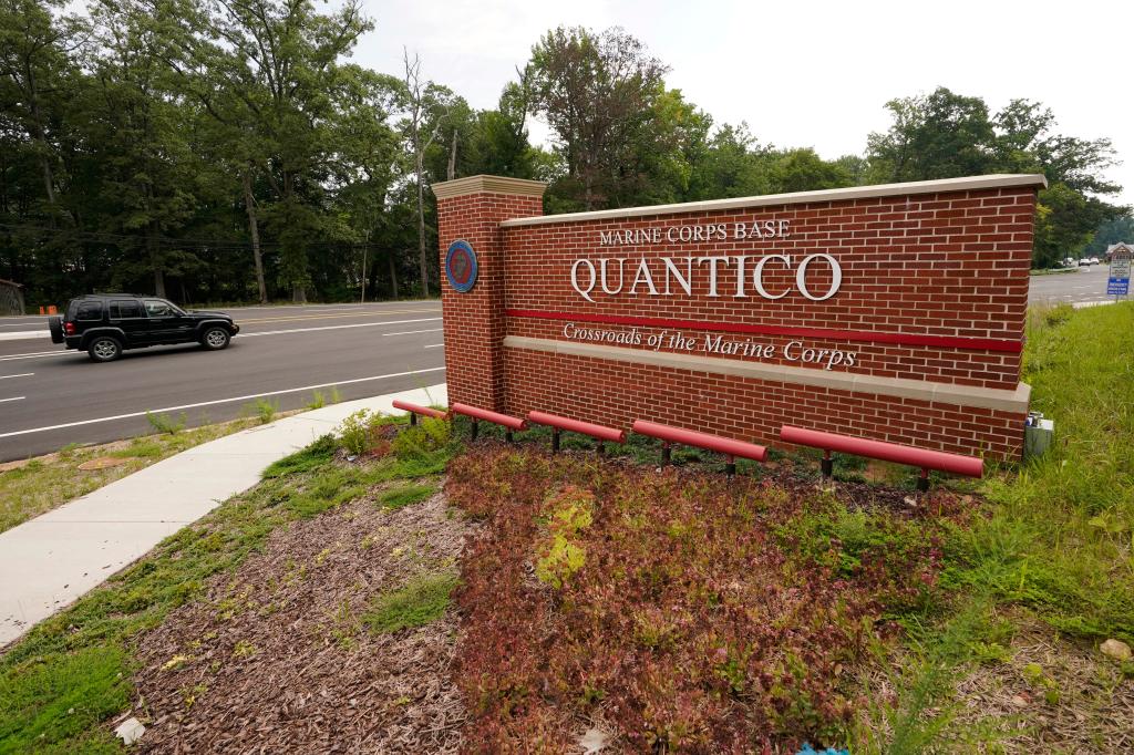 Traffic drives past the entrance sign of Marine Corps Base Quantico