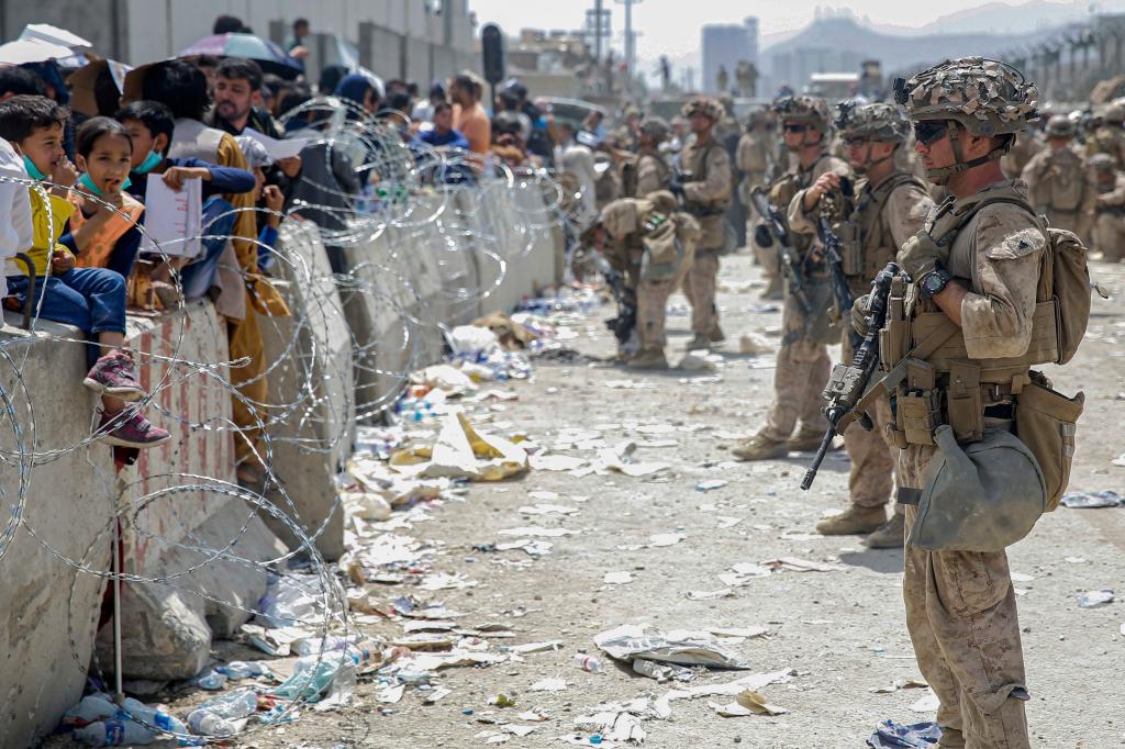 U.S. Marines with Special Purpose Marine Air-Ground Task Force - Crisis Response - Central Command, provide assistance during an evacuation at Hamid Karzai International Airport in Kabul, Afghanistan, Aug. 20, 2021.