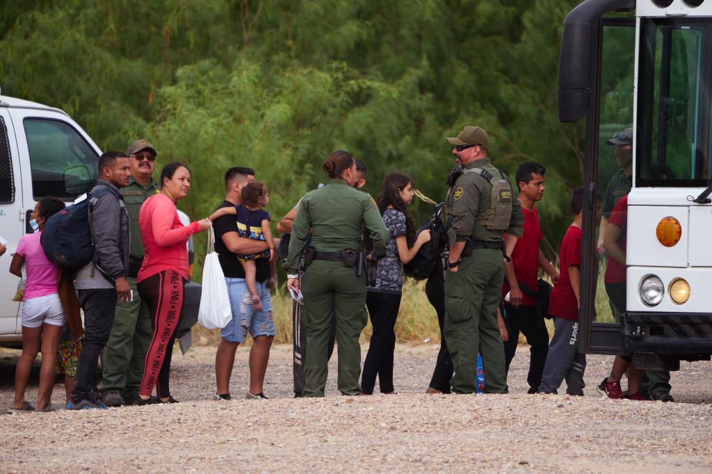 Migrants are processed by U.S. Customs and Border Protection officers after crossing the United States-Mexico border on Friday, July 22, 2022 in Eagle Pass, Texas