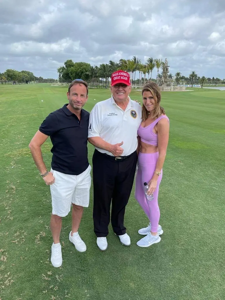 Braun poses with former President Trump on a golf course 