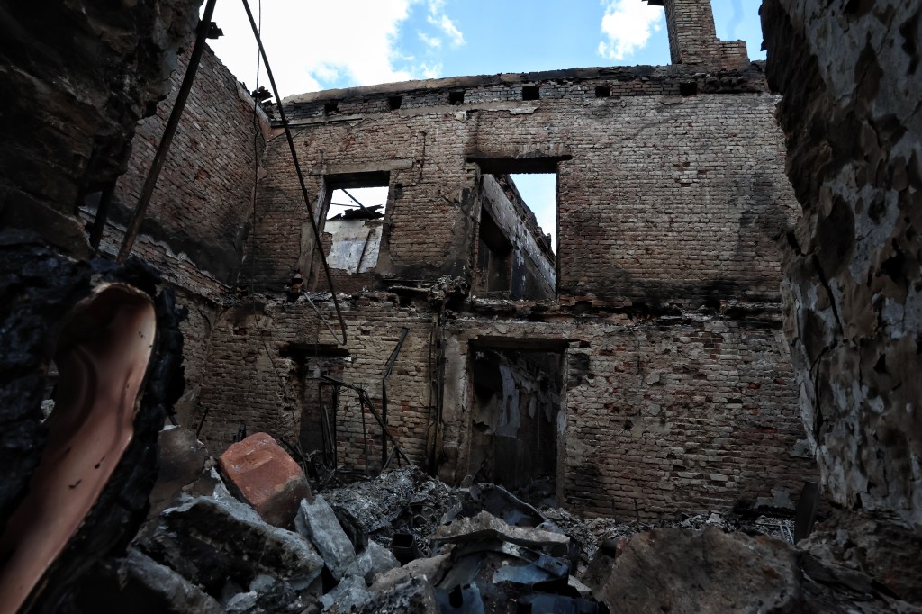 Rubble and debris from a brick building destroyed due to hostilities in Sudzha, Russia on August 16, 2024, against a backdrop of a clear blue sky