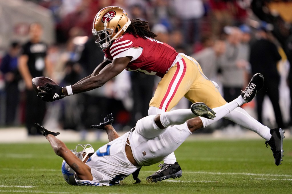  San Francisco 49ers wide receiver Brandon Aiyuk, top, catches a pass against Detroit Lions cornerback Kindle Vildor (29) during the second half of the NFC Championship NFL football game in Santa Clara, Calif., Sunday, Jan. 28, 2024.