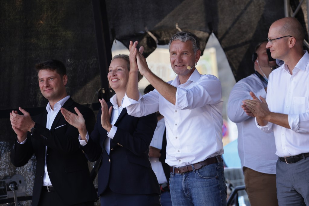 Björn Höcke, Alice Weidel, and Rene Aust of the far-right Alternative for Germany (AfD) party, waving to supporters during a campaign rally in Erfurt, Germany, before Thuringia state elections in 2024.