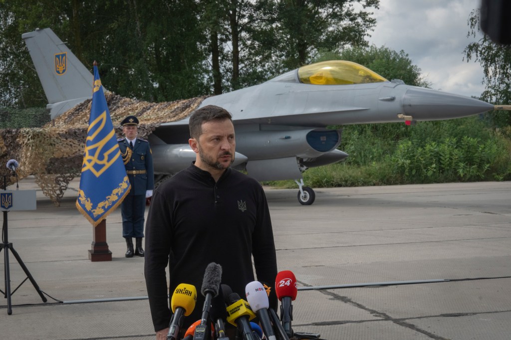 Ukraine's President Volodymyr Zelensky speaking in front of Ukraine's Air Force's F-16 fighter jets on Aug. 4, 2024.