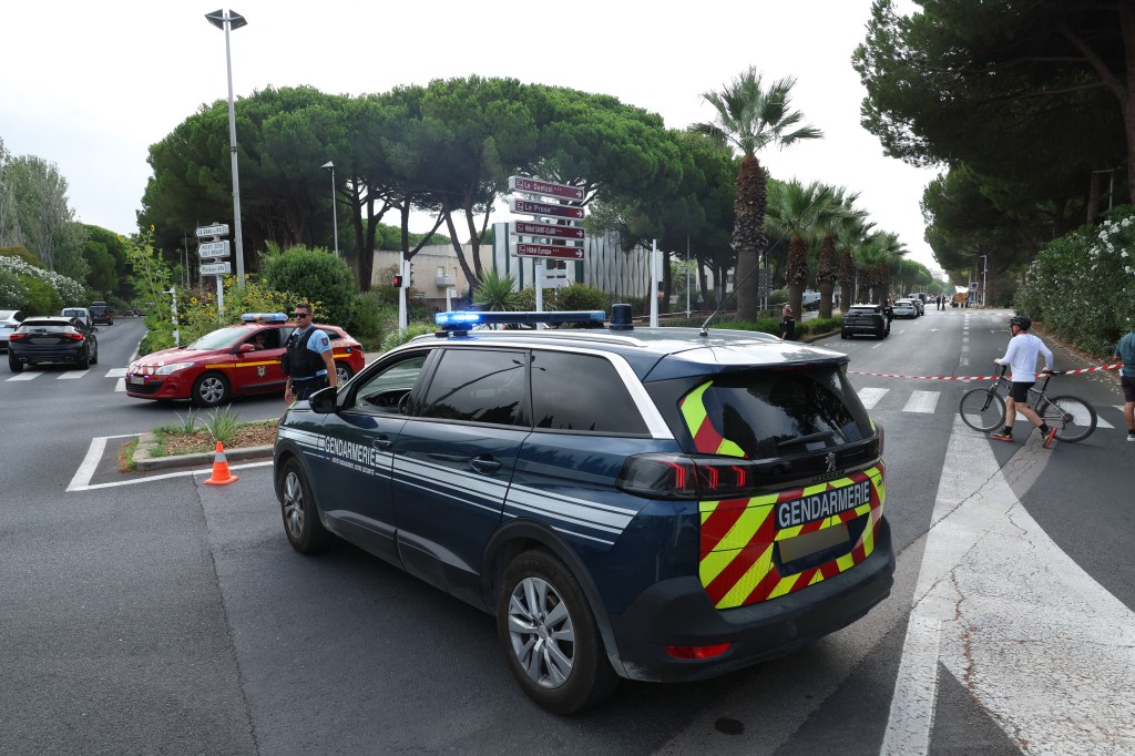 A French officer blocks the road nearby the synagogue following the fire and explosion of cars in La Grande-Motte, south of France.