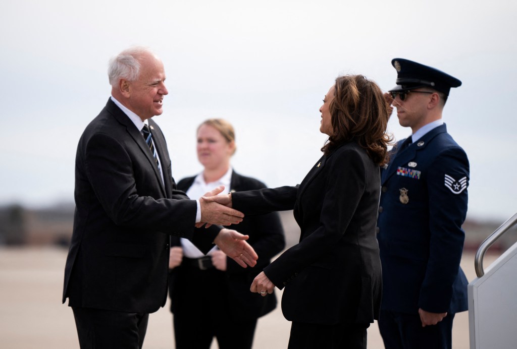 Minnesota Governor Tim Walz greets US Vice President Kamala Harris as she arrives at the Minneapolis-St. Paul International Airport in Saint Paul, Minnesota, on March 14, 2024.