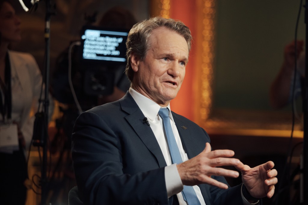 Brian Moynihan, CEO of Bank of America, in a suit and tie during a television interview in Versailles, France, discussing the state of US consumers and businesses in 2024