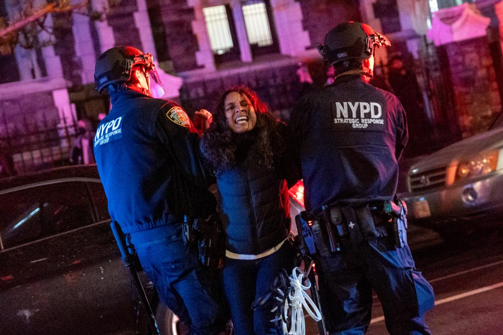 A woman being arrested by cops in NYC streets.