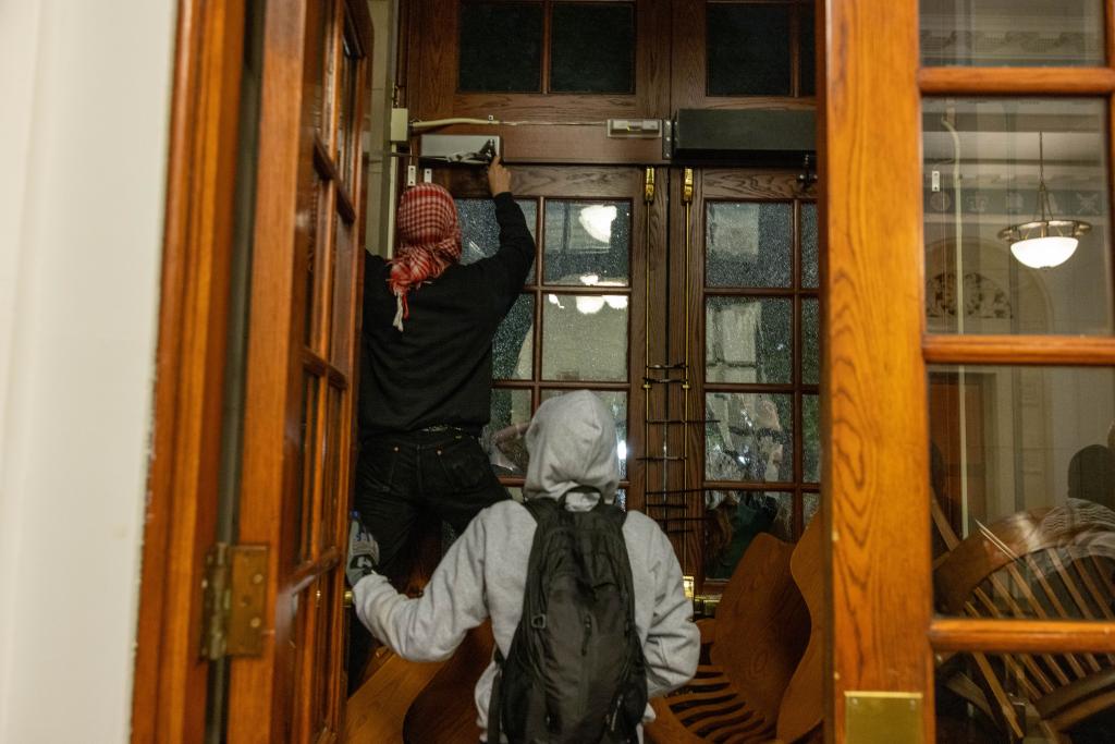 Demonstrators from the pro-Palestine encampment on Columbia's Campus barricade themselves inside Hamilton Hall, where the office of the Dean is located on Tuesday, April 30, 2024 in New York City