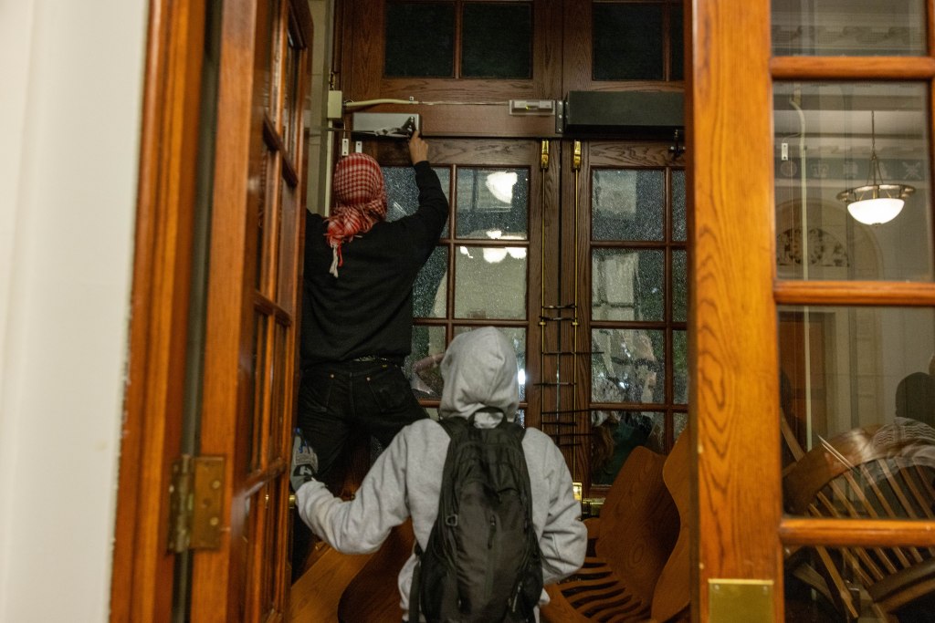 Demonstrators from the pro-Palestine encampment on Columbia's Campus barricade themselves inside Hamilton Hall, where the office of the Dean is located on Tuesday, April 30, 2024 in New York City