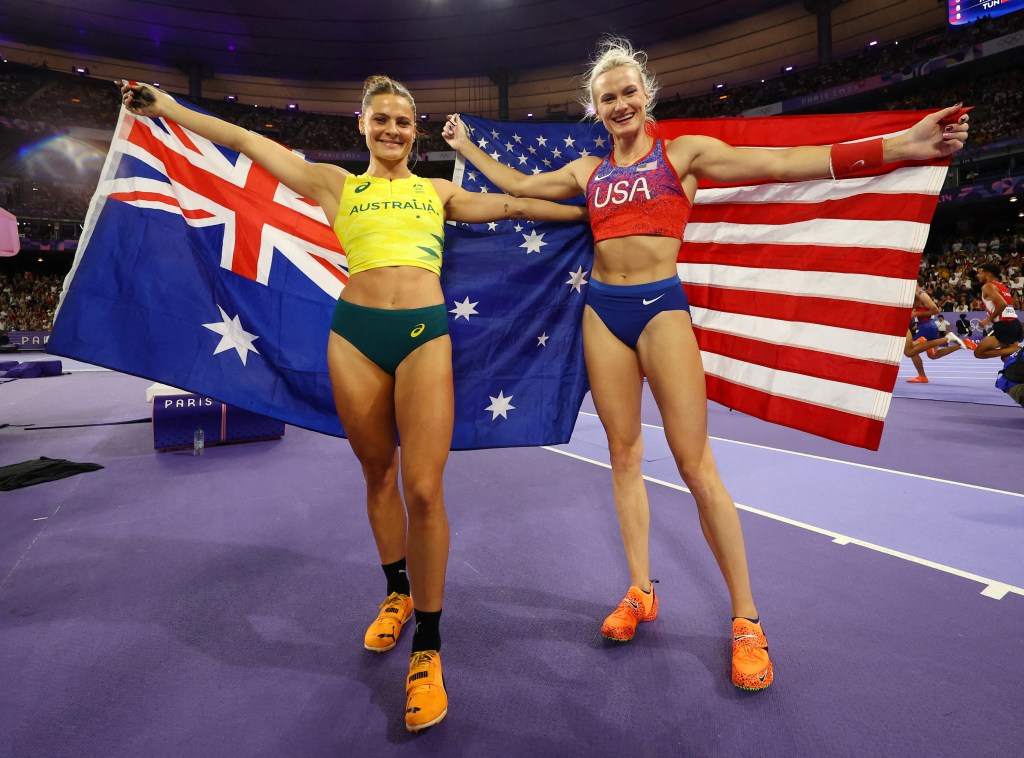 Nina Kennedy of Australia celebrates with her national flag after winning gold with silver medallist Katie Moon of United States