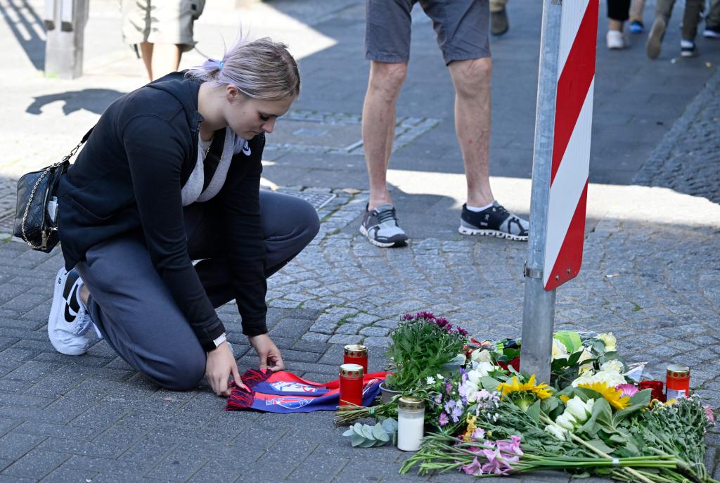 Mourning citizens create a vigil for the victims who were killed as the town celebrated its 650th anniversary. 